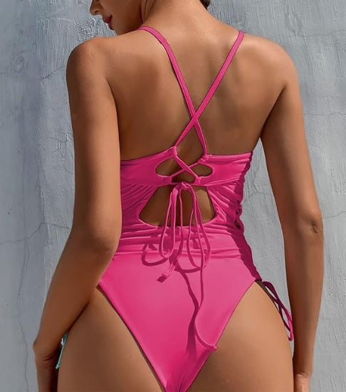 Roze badpak met vetersluiting en uitsparingen - Bakkermode.nl