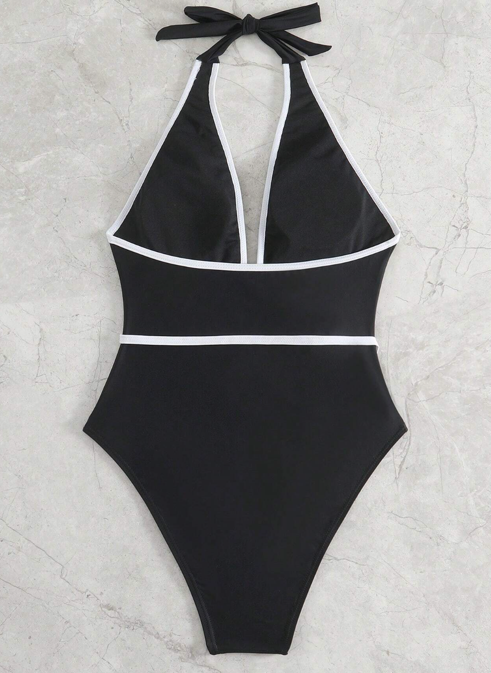 Zwart halter badpak met witte rand en bloemdetail - Bakkermode.nl