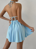 Halterjurk met diepe V-hals en strikbanden - Bakkermode.nl