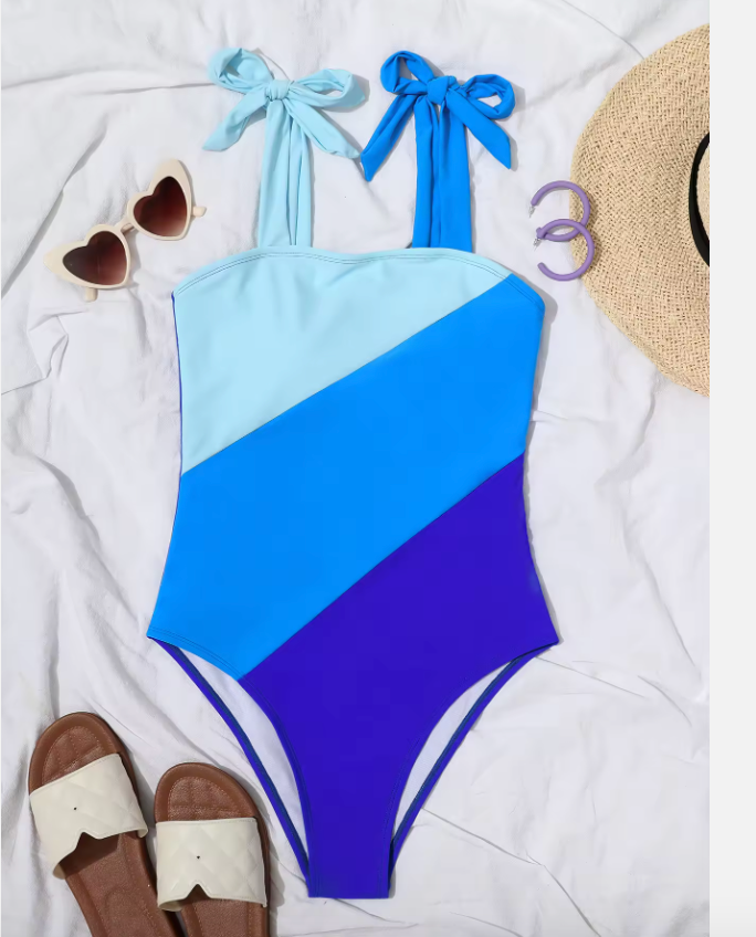 Blauw badpak met kleurblokken en strikbandjes - Bakkermode.nl