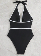 Zwart halter badpak met witte rand en bloemdetail - Bakkermode.nl