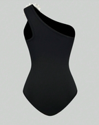 Zwart asymmetrisch badpak met witte bloem - Bakkermode.nl