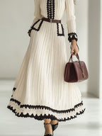 Gebreide midi-jurk - tijdloze damesmode met ceintuur